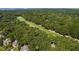 Lush, green golf course winds through dense trees in an expansive aerial view showcasing the surrounding landscape at 807 Treeloft Trce, Seabrook Island, SC 29455