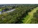 Breathtaking aerial view showcasing a golf course, a serene pond, and mature trees near a coastal waterway at 807 Treeloft Trce, Seabrook Island, SC 29455