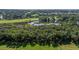Sweeping aerial view featuring a golf course, pond, mature trees, and houses, near a coastal waterway with a beach at 807 Treeloft Trce, Seabrook Island, SC 29455