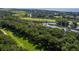 Stunning aerial view captures a picturesque golf course, lake, mature trees, and houses near a waterway and marsh at 807 Treeloft Trce, Seabrook Island, SC 29455