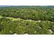 Expansive aerial view of a lush, green golf course winding through dense trees and near coastal waterways at 807 Treeloft Trce, Seabrook Island, SC 29455