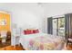 Bright bedroom with floral bedspread, ensuite bathroom, and balcony access at 807 Treeloft Trce, Seabrook Island, SC 29455