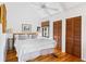 Bright bedroom with white ceiling, wooden floors, and shuttered closet doors at 807 Treeloft Trce, Seabrook Island, SC 29455