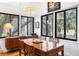 Bright dining room with wood table and chairs, offering views of the surrounding greenery at 807 Treeloft Trce, Seabrook Island, SC 29455