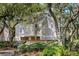 Charming raised home featuring a neutral exterior, lush landscaping, and inviting staircase at 807 Treeloft Trce, Seabrook Island, SC 29455