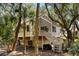 Exterior view of a quaint home with stairs leading to a porch, nestled among palm trees at 807 Treeloft Trce, Seabrook Island, SC 29455