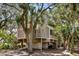 Inviting exterior view of home with a small porch, surrounded by lush landscaping and mature trees at 807 Treeloft Trce, Seabrook Island, SC 29455