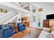 Open living space featuring vaulted ceilings, fireplace, and staircase to a second floor at 807 Treeloft Trce, Seabrook Island, SC 29455