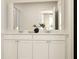 Bright primary bathroom features large mirror, double sink vanity, and views of the bedroom in the mirror at 8750 Silver Perch Ln, North Charleston, SC 29420