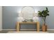 Stylish entryway console table is decorated with a round mirror, lamps, and a plant at 8752 Silver Perch Ln, North Charleston, SC 29420