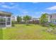 Expansive backyard with green grass, mature trees, and a wooden fence at 9998 Winged Elm St, Ladson, SC 29456