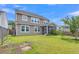 Spacious backyard with a well-maintained lawn and a cozy screened-in porch at 9998 Winged Elm St, Ladson, SC 29456