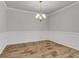 Elegant dining room with modern chandelier, wainscoting and wood-look floors at 9998 Winged Elm St, Ladson, SC 29456