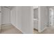 A hallway area providing a view of the bathroom and doorway, bathed in natural light at 9998 Winged Elm St, Ladson, SC 29456