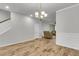 Bright living room features hardwood floors, a chandelier, and staircase at 9998 Winged Elm St, Ladson, SC 29456