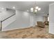 Spacious living room with hardwood floors, staircase, and a chandelier at 9998 Winged Elm St, Ladson, SC 29456