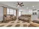 Spacious living room featuring hardwood floors, ceiling fan, and plush seating at 9998 Winged Elm St, Ladson, SC 29456