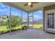 Relaxing screened porch with string lights, offering a view of the serene backyard at 9998 Winged Elm St, Ladson, SC 29456