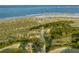 Breathtaking aerial view of the beach, dunes, and boardwalk creating a stunning coastal panorama at 10 Ocean Point Dr, Isle of Palms, SC 29451