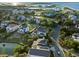 Aerial view of waterfront homes surrounded by lush greenery and a scenic river at 10 Ocean Point Dr, Isle of Palms, SC 29451