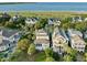 Aerial view of waterfront home with a screened porch and lush landscaping at 10 Ocean Point Dr, Isle of Palms, SC 29451