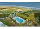 Beautiful aerial showcases a pool, cabana, and lush landscaping near the ocean at 10 Ocean Point Dr, Isle of Palms, SC 29451