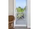 Balcony view showcases lush greenery and a glimpse of the ocean, perfect for relaxing outdoors at 10 Ocean Point Dr, Isle of Palms, SC 29451