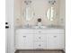 Bathroom with marble countertop vanity, dual sinks, and decorative mirrors at 10 Ocean Point Dr, Isle of Palms, SC 29451