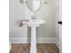 Bathroom featuring a pedestal sink, vanity mirror and tile floor at 10 Ocean Point Dr, Isle of Palms, SC 29451