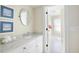 Bathroom featuring an extended vanity, vanity mirror, and step-in shower at 10 Ocean Point Dr, Isle of Palms, SC 29451