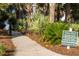 Landscaped path to the beach access with a sign at 10 Ocean Point Dr, Isle of Palms, SC 29451