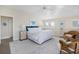Bright, airy bedroom boasts a vaulted ceiling, neutral decor, and comfortable seating area with rattan chairs at 10 Ocean Point Dr, Isle of Palms, SC 29451