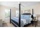 Bedroom featuring a four-poster bed, ceiling fan and shuttered windows at 10 Ocean Point Dr, Isle of Palms, SC 29451