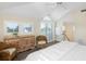 Bedroom featuring vaulted ceiling, shuttered windows, dresser, and comfortable rattan seating area at 10 Ocean Point Dr, Isle of Palms, SC 29451