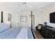 Bedroom featuring a four-poster bed, ceiling fan, TV, shuttered windows, and ensuite bath at 10 Ocean Point Dr, Isle of Palms, SC 29451