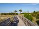 Picturesque boardwalk framed by lush dunes and swaying palms evokes tranquility at 10 Ocean Point Dr, Isle of Palms, SC 29451