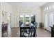 Dining room with a view of the green golf course, and French doors to the outside at 10 Ocean Point Dr, Isle of Palms, SC 29451