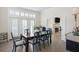 Bright dining room with a dark wood table, patterned chairs, and bright windows at 10 Ocean Point Dr, Isle of Palms, SC 29451