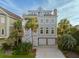Charming multi-story beach house with a two-car garage and well-maintained landscaping at 10 Ocean Point Dr, Isle of Palms, SC 29451