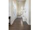 Bright foyer featuring hardwood floors, staircase, and a charming built-in bench with coat hooks and storage at 10 Ocean Point Dr, Isle of Palms, SC 29451