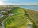 Scenic aerial of a golf course winding along the coastline, with beach views at 10 Ocean Point Dr, Isle of Palms, SC 29451