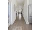 Hallway with hardwood floors and bright white trim with stainless steel refrigerator at 10 Ocean Point Dr, Isle of Palms, SC 29451