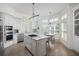 Spacious kitchen with white cabinets, marble countertops, and stainless steel appliances at 10 Ocean Point Dr, Isle of Palms, SC 29451