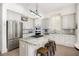 Bright kitchen featuring stainless steel appliances, a granite island, and bright lighting at 10 Ocean Point Dr, Isle of Palms, SC 29451