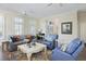 Bright living room featuring hardwood floors, plantation shutters, and comfortable seating arrangement at 10 Ocean Point Dr, Isle of Palms, SC 29451