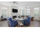Bright living room with fireplace, comfortable seating, and large windows with plantation shutters at 10 Ocean Point Dr, Isle of Palms, SC 29451