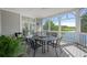 Relaxing screened porch with outdoor dining set, providing views of the water and a serene environment at 10 Ocean Point Dr, Isle of Palms, SC 29451
