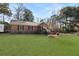 Charming brick home featuring a well-maintained lawn and classic architectural details at 1027 Yeamans Hall Rd, Hanahan, SC 29410