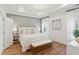 Inviting bedroom featuring a tray ceiling, hardwood floors, and abundant natural light at 1030 Sagegrass St, Summerville, SC 29485