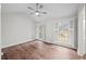 Bright bedroom featuring hardwood floors, two windows, and a ceiling fan at 1043 Dominion Dr, Hanahan, SC 29410